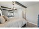Charming bedroom with wood beam accents, neutral colors, and cozy carpet flooring at 13905 W 21St Ave, Golden, CO 80401