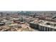 Wide aerial view of city buildings, parking lots, and roads on a clear day at 2318 Arapahoe St, Denver, CO 80205