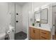 An elegant bathroom features a glass enclosed shower and wood vanity with modern fixtures at 2318 Arapahoe St, Denver, CO 80205