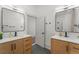 A bright bathroom features dual sinks and a modern design with wood cabinets and updated fixtures at 2318 Arapahoe St, Denver, CO 80205