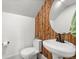 Chic half bathroom featuring a unique wood accent wall, modern sink, and a stylish mirror at 2318 Arapahoe St, Denver, CO 80205