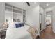 A cozy bedroom boasts custom built-in shelving and pristine hardwood floors at 2318 Arapahoe St, Denver, CO 80205