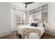 Bright bedroom featuring built-in shelving, a ceiling fan, and a large window offering nice city views at 2318 Arapahoe St, Denver, CO 80205