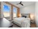 Modern bedroom with exposed brick wall, large windows and neutral decor at 2318 Arapahoe St, Denver, CO 80205