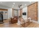 Bright living room with exposed brick, wood floors, and contemporary furniture at 2318 Arapahoe St, Denver, CO 80205
