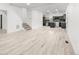 A spacious, open-concept living area with wood flooring seamlessly integrates the kitchen and staircase at 400 Division Blvd, Platteville, CO 80651