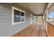 Covered porch featuring rich wood and gray trim which provides an ideal spot for relaxation at 400 Division Blvd, Platteville, CO 80651