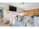 Bedroom features a mounted television, closet, and view into the attached bathroom at 977 S Salida St, Aurora, CO 80017