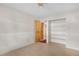 Bright bedroom featuring a built-in shelving unit and light hardwood floors at 977 S Salida St, Aurora, CO 80017