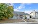 Charming single-story home featuring mature landscaping, a cozy front porch, and attached garage at 977 S Salida St, Aurora, CO 80017