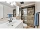 Updated bathroom featuring a glass shower enclosure, modern fixtures, and a vanity with sink at 961 S Miller Way, Lakewood, CO 80226