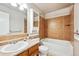 Bathroom featuring a combined shower and tub with tile surround, vanity with sink and storage at 961 S Miller Way, Lakewood, CO 80226