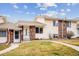 Charming townhouse featuring a well-manicured lawn and inviting front porch, perfect for enjoying the outdoors at 961 S Miller Way, Lakewood, CO 80226
