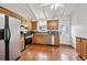 Well-lit kitchen features stainless steel appliances, wood cabinets and hardwood floors, making it both functional and stylish at 961 S Miller Way, Lakewood, CO 80226