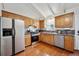 Featuring stainless steel appliances, wood cabinets, mosaic backsplash, this kitchen offers a perfect blend of style and efficiency at 961 S Miller Way, Lakewood, CO 80226