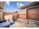 Enclosed patio with concrete flooring and wooden fencing, offering privacy and outdoor space at 961 S Miller Way, Lakewood, CO 80226