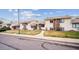 A view of the townhouses on a tree-lined street, each with unique front lawns that provides curb appeal at 961 S Miller Way, Lakewood, CO 80226