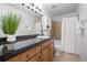 Clean bathroom featuring a dark vanity, a mirror, and shower-tub combination at 8603 E Dry Creek Rd # 214, Englewood, CO 80112
