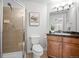 Tiled bathroom with a glass-enclosed shower, a vanity, and modern fixtures at 8603 E Dry Creek Rd # 214, Englewood, CO 80112