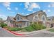 Exterior of multi-Gathering home features manicured landscaping, a private balcony, and clearly marked reserved parking at 8603 E Dry Creek Rd # 214, Englewood, CO 80112