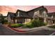 Exterior of multi-Gathering home at dusk features manicured landscaping and a private balcony at 8603 E Dry Creek Rd # 214, Englewood, CO 80112