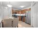 Kitchen features stainless steel appliances, tile floor, and an open floor plan into the dining area at 8603 E Dry Creek Rd # 214, Englewood, CO 80112
