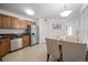 Kitchen features stainless steel appliances, tile floor, and an open floor plan into the dining area at 8603 E Dry Creek Rd # 214, Englewood, CO 80112