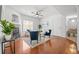 Bright living room boasts a fireplace, wood floors, ceiling fan, two chairs, and an open floor plan at 8603 E Dry Creek Rd # 214, Englewood, CO 80112