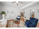 Bright living room features an open floor plan with wood floors, two arm chairs and a ceiling fan at 8603 E Dry Creek Rd # 214, Englewood, CO 80112