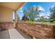 Brick patio area with a partial brick wall offering privacy and shade at 8603 E Dry Creek Rd # 214, Englewood, CO 80112