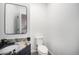 Well-lit bathroom with a modern mirror, granite countertop, stylish sink, and a white toilet at 9350 W Florida Ave, Lakewood, CO 80232