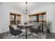 Cozy dining room with hardwood floors, modern lighting, and large windows providing ample natural light at 9350 W Florida Ave, Lakewood, CO 80232