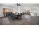 Bright dining room with stylish furniture, chandelier, wood-look floors, and views into living and kitchen at 9350 W Florida Ave, Lakewood, CO 80232