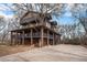 Stunning three-story home with multiple balconies and a large tree integrated into the design at 9350 W Florida Ave, Lakewood, CO 80232