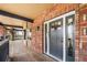 Inviting front door with detailed brickwork and a covered porch, exuding charm at 9350 W Florida Ave, Lakewood, CO 80232