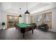 Entertainers dream: Spacious game room with a pool table, comfortable seating, and views of the natural landscape at 9350 W Florida Ave, Lakewood, CO 80232