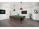A recreation room showcases a billiard table with pendant lighting, with neutral walls and flooring at 9350 W Florida Ave, Lakewood, CO 80232