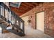 Garage access with stairs leading to the upper level, showcasing brickwork and design at 9350 W Florida Ave, Lakewood, CO 80232