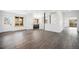 Open-concept living space with hardwood floors, large windows, and modern lighting at 9350 W Florida Ave, Lakewood, CO 80232