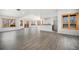 Bright living room with sleek floors, lots of windows and a partial view of the kitchen at 9350 W Florida Ave, Lakewood, CO 80232