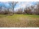 Sprawling lot featuring mature trees and a lush green lawn, ideal for building your dream home at 9350 W Florida Ave, Lakewood, CO 80232