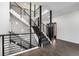 Stunning staircase featuring hardwood floors, iron railings, stylish lighting, and a modern design at 9350 W Florida Ave, Lakewood, CO 80232