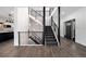 Modern staircase features hardwood floors, iron railings, and stylish light fixtures at 9350 W Florida Ave, Lakewood, CO 80232