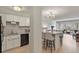 Modern kitchen with white cabinets, stainless appliances, and breakfast bar at 800 N Washington St # 307, Denver, CO 80203