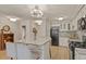 Modern kitchen featuring an island with bar seating, white cabinets and sleek appliances at 800 N Washington St # 307, Denver, CO 80203