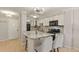 Well-lit kitchen with white cabinets, granite counters, and eat-in island at 800 N Washington St # 307, Denver, CO 80203