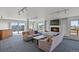 Bright living room features plush sofas, a modern fireplace, and access to a terrace with city views at 800 N Washington St # 307, Denver, CO 80203