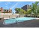 Outdoor pool surrounded by lush greenery and a view of the city skyline at 800 N Washington St # 307, Denver, CO 80203