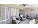 Relaxing sunroom with sliding glass doors, comfortable seating, and a ceiling fan at 800 N Washington St # 307, Denver, CO 80203