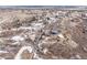 Aerial view showcasing a large home, detached garage, and expansive property with a tennis court at 1175 Ridge Oaks Dr, Castle Rock, CO 80104